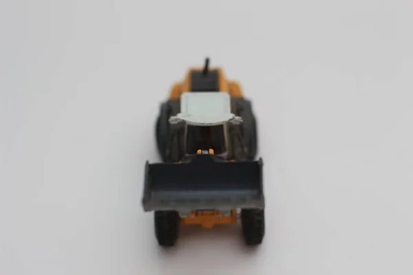 Close Miniature Orange Wheel Loader Toy Isolated White Background Concept — Foto de Stock
