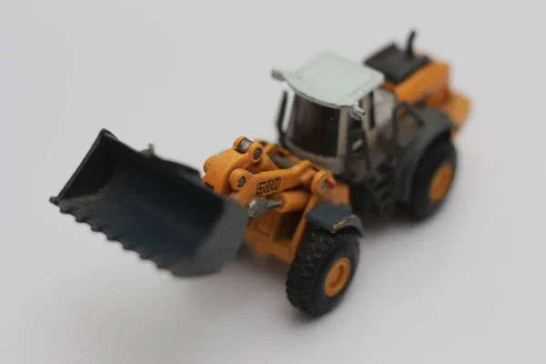 Close Miniature Orange Wheel Loader Toy Isolated White Background Concept — Stockfoto
