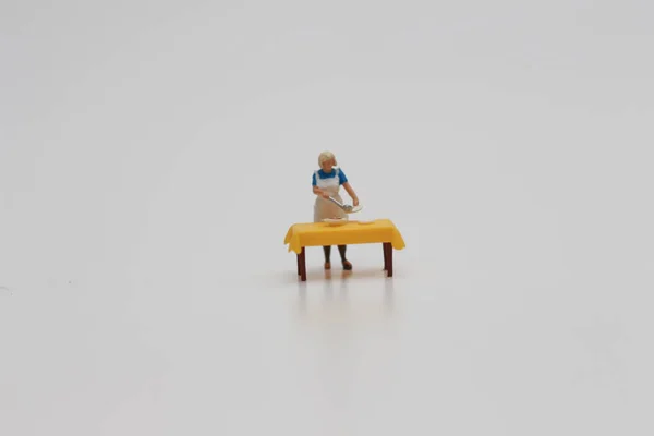 Close Miniature Figure Woman Serving Food Table Isolated White Background — Fotografia de Stock