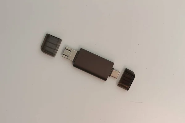 a close up of multifunction USB OTG adapter type A to type C and micro USB type which is gray isolated on white background. technology product photo concept.
