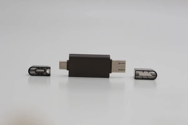 a close up of multifunction USB OTG adapter type A to type C and micro USB type which is gray isolated on white background. technology product photo concept.