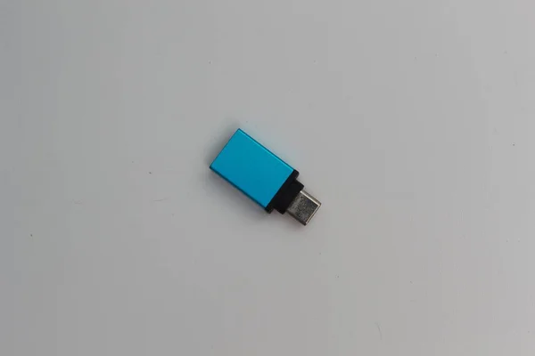 A close up of USB OTG (On The Go) Type C to Type A adapters with blue color isolated on a white background. technology product photo concept.