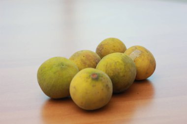 greenish yellow harp fruit isolated on money table has sweet and sour taste. Food concept photo.