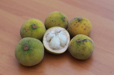 greenish yellow harp fruit isolated on money table has sweet and sour taste. Food concept photo.