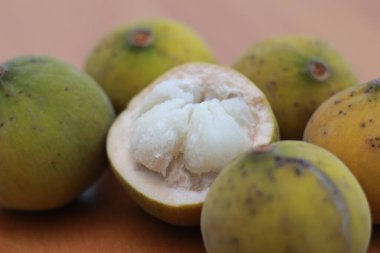 greenish yellow harp fruit isolated on money table has sweet and sour taste. Food concept photo.