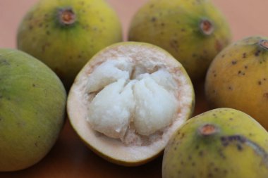 greenish yellow harp fruit isolated on money table has sweet and sour taste. Food concept photo.