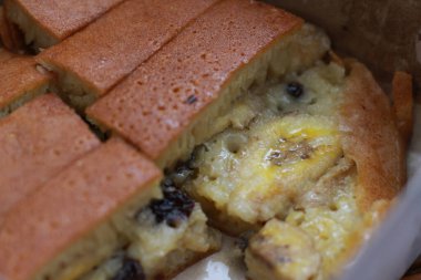 a dish called sweet martabak topped with raisins and bananas tastes sweet and is filling. made from flour dough. served warm. Food concept photo.