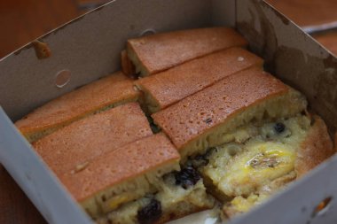 a dish called sweet martabak topped with raisins and bananas tastes sweet and is filling. made from flour dough. served warm. Food concept photo.