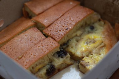 a dish called sweet martabak topped with raisins and bananas tastes sweet and is filling. made from flour dough. served warm. Food concept photo.