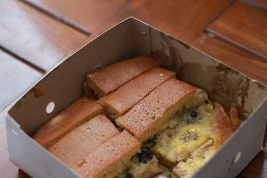 a dish called sweet martabak topped with raisins and bananas tastes sweet and is filling. made from flour dough. served warm. Food concept photo.