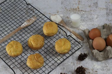 a traditional cake from Indonesia called kue sus filled with cream puffs. served on a cake rack. Food concept photo.