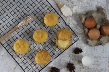 a traditional cake from Indonesia called kue sus filled with cream puffs. served on a cake rack. Food concept photo.