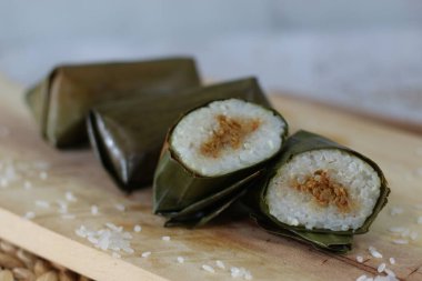 a close up of lontong. Traditional food from Indonesia originating from rice filled with vegetables or meat and wrapped in banana leaves. Indonesian traditional food photo concept.