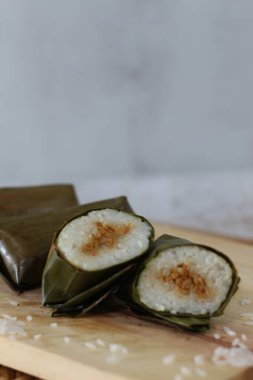 a close up of lontong. Traditional food from Indonesia originating from rice filled with vegetables or meat and wrapped in banana leaves. Indonesian traditional food photo concept.
