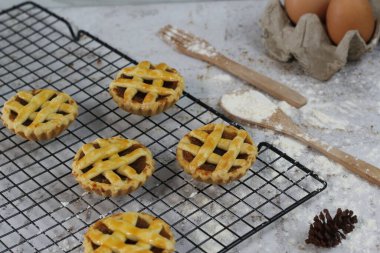 Small apple pie served on a cake rack, tastes sweet and savory. Food concept photo.