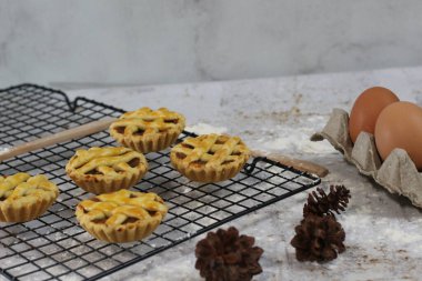 Pasta rafında servis edilen küçük elmalı turta, tatlı ve lezzetli. Yemek konsepti fotoğrafı.