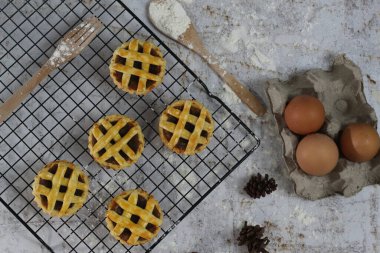 Small apple pie served on a cake rack, tastes sweet and savory. Food concept photo.