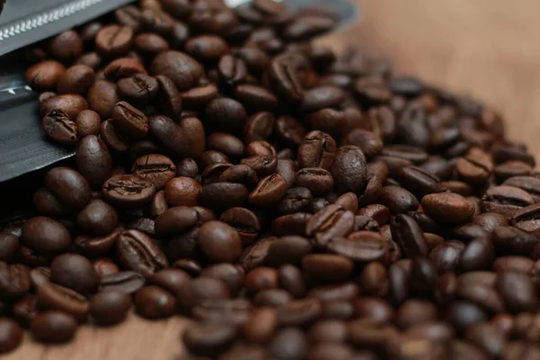 stock image Detailed photo of coffee beans before being processed into a drink isolated on wood. Concept photo of the basic ingredients of coffee drinks.