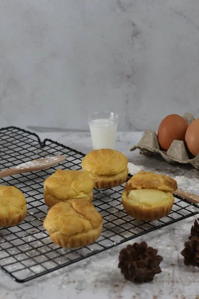 a traditional cake from Indonesia called kue sus filled with cream puffs. served on a cake rack. Food concept photo.