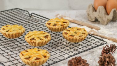 Small apple pie served on a cake rack, tastes sweet and savory. Food concept photo.