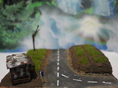 a close up of a diorama of a rice field scene and an old roadside house. miniature diorama photo concept.