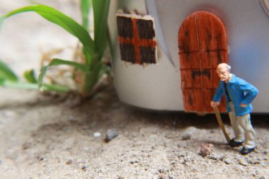 miniature figure of a grandfather who is waiting in front of the house.