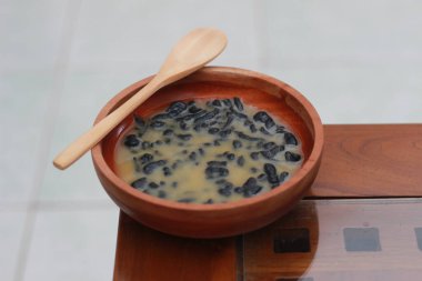 a close up of a bowl of traditional Indonesian drink called Dawet Ireng or black dawet. Indonesian traditional food photo concept.
