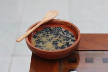 a close up of a bowl of traditional Indonesian drink called Dawet Ireng or black dawet. Indonesian traditional food photo concept.