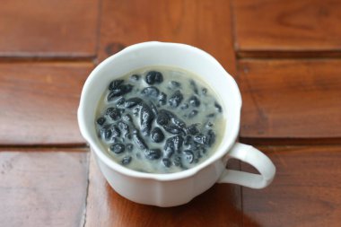 a close up of a glass of a traditional Indonesian drink called Dawet Ireng or black dawet. Indonesian traditional food photo concept.