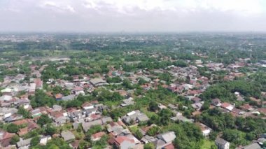 4K footage aerial view of residential area filled with greenery.