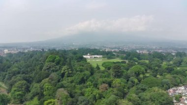 Bogor, Indonesia - Bogor, October 22 2022. 4K footage aerial view of the presidential palace building in the middle of a botanical garden.