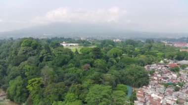 Bogor, Indonesia - Bogor, October 22 2022. 4K footage aerial view of the presidential palace building in the middle of a botanical garden.
