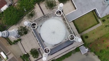 aerial view of the majestic white grand mosque on a sunny day.