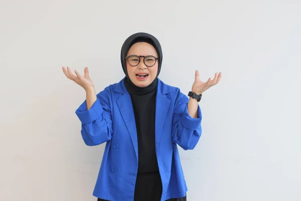 美しい若いアジアのイスラム教徒の女性は 白い背景に隔離されたストレスジェスチャーを示す眼鏡と青のブレザーを着用 広告コンセプト — ストック写真