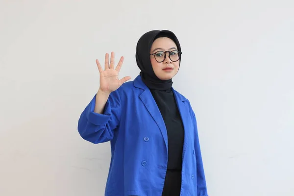 美しい若いアジアのイスラム教徒の女性は 白い背景を笑顔ながらヤシの木を示す眼鏡と青いブレザーを身に着けている 広告コンセプト — ストック写真