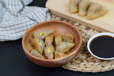 Closeup of Pempek, a traditional Indonesian fish cake served with savory sauce.  A delicious and satisfying snack. clipart