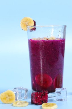 Muz ve kırmızı ejderha meyveli sağlıklı taze meyve suyu. Parlak arka planda izole edilmiş bardaklarda. sağlıklı diyet fotoğrafı konsepti.