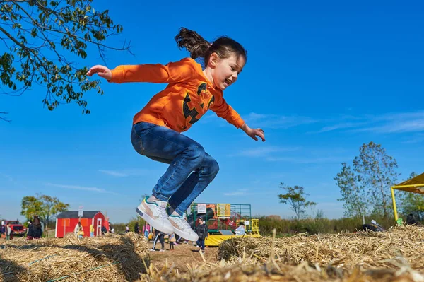 Pretty Girl Jumping Hay Stacks Farm Fair Halloween — Stock Photo, Image