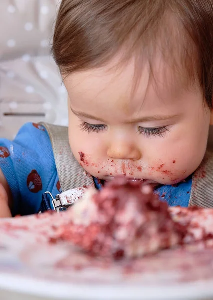 stock image first birthday celebration and fist time eating cake for this little boy