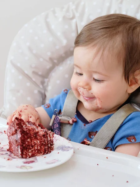 stock image first birthday celebration and fist time eating cake for this little boy