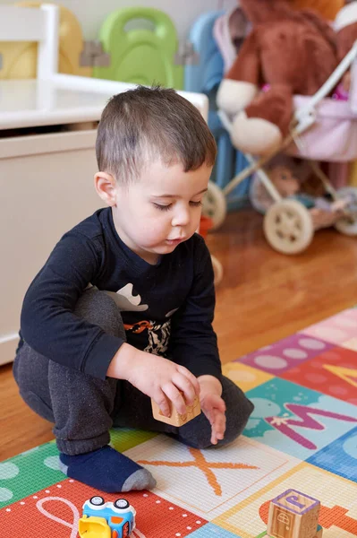 stock image cute young boy playing with toys in the baby room at home