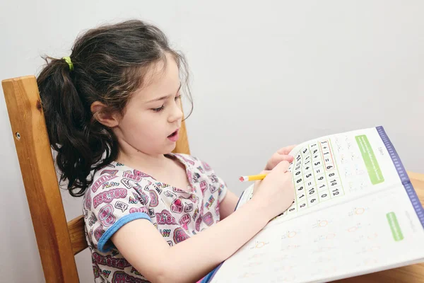 Cute Girl Rozwiązywanie Zagadek Matematycznych Stole Kuchni — Zdjęcie stockowe
