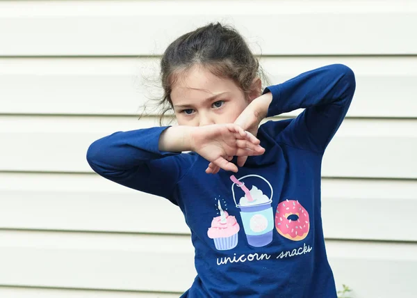 stock image young girl posing and making faces in the backyard