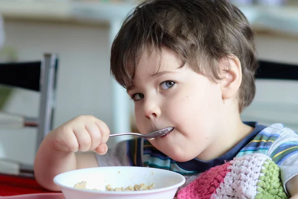 stock image close up of a young boy eating oatmeal for breakfast