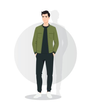 Koyu yeşil ceketli ve siyah kazaklı genç bir adam. Tarz imajı siyah pantolon ve beyaz spor ayakkabılarla vurgulanıyor. Kendinden emin ve rahat bir görünüm..