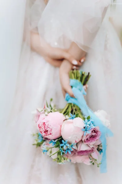Beautiful wedding rustic bouquet with white roses. In bride hand. High quality photo