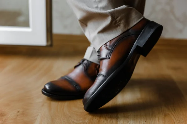 Elegant and hipster grooms shoes with cool socks. Wedding photography concept. Selective focus.j. High quality photo