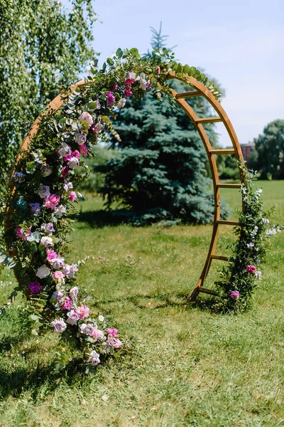 Arch with white flowers and greenery for wedding ceremony in the trend style. Beautiful wedding decoration. . High quality photo