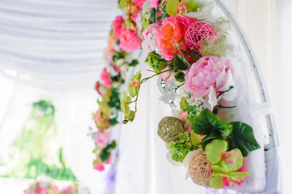 stock image Beautiful white wedding arch decorated with pink and red flowers outdoors . High quality photo