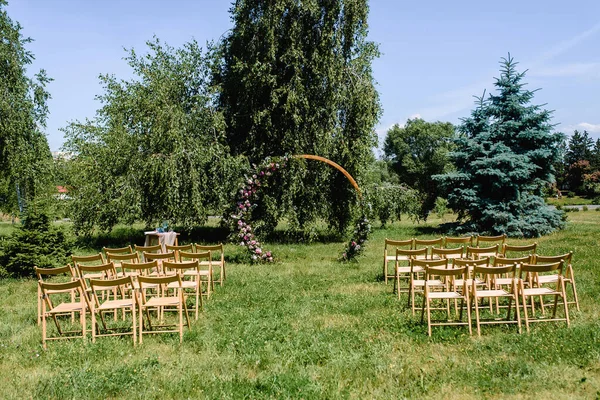 wedding ceremony. wooden arch in rustic style decorated flowers. High quality photo